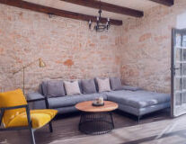 a living room with a brick wall
